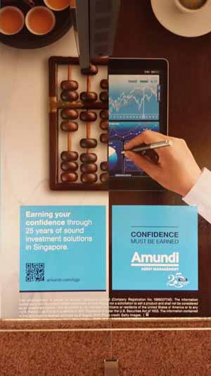 Wall ad for Amundi Asset Management featuring a QR code.