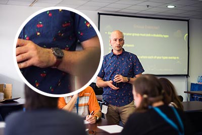 Me conducting a workshop, with an enlarged view of the watch on my wrist.