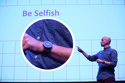 Me on stage at a conference, with an enlarged view of the watch on my wrist.