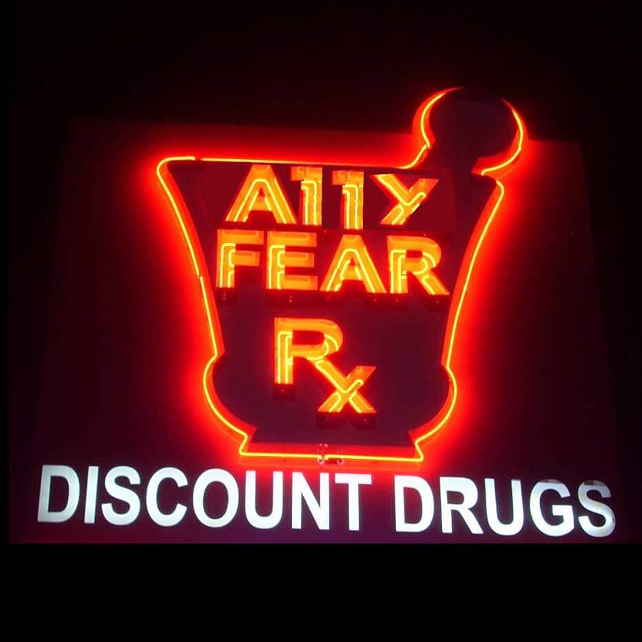 A discount drugs sign, that in neon reads A11y Fear.